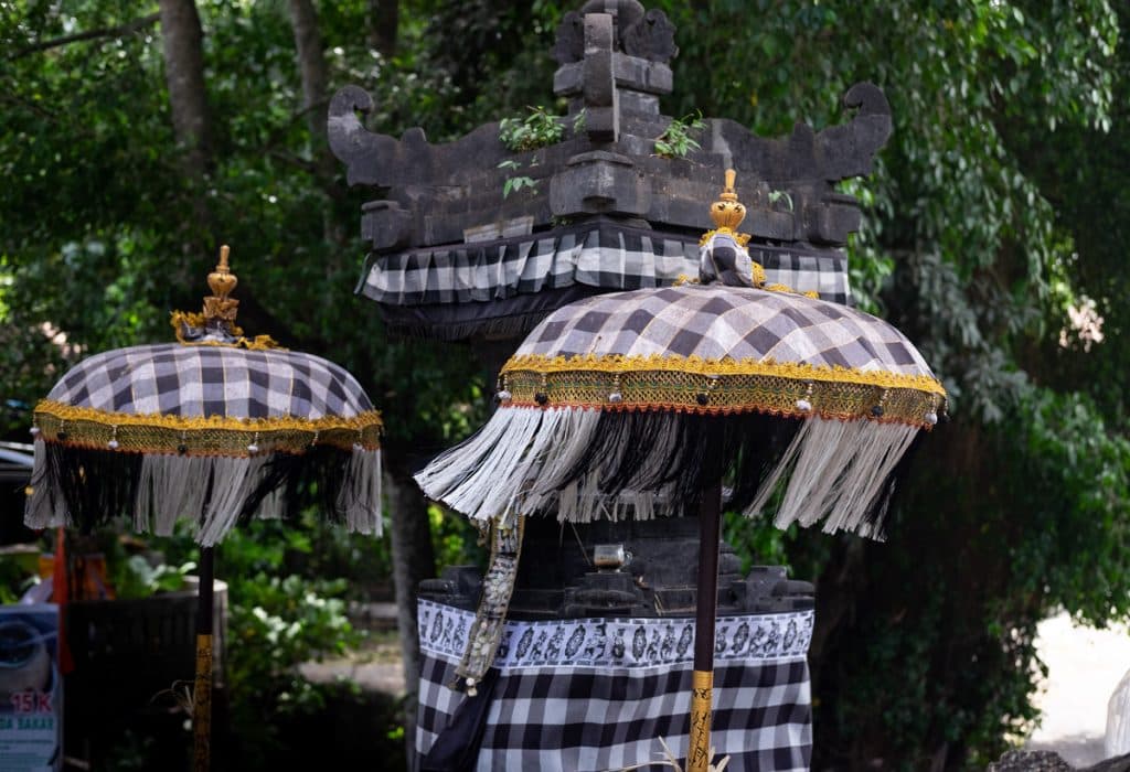 Balinese temple dressed in black and white checked cloth