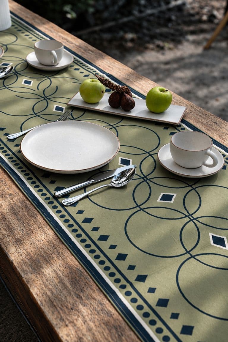 Outdoor table set with green KIND printed linens