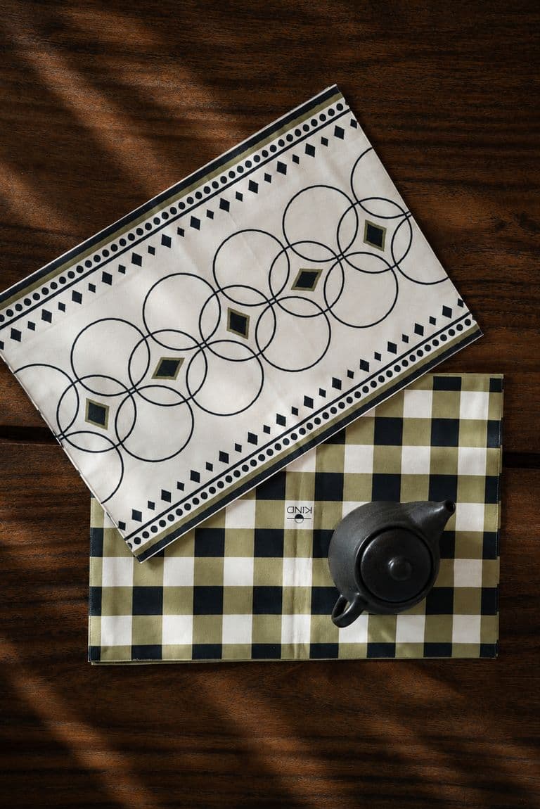 Black circle print and green checked KIND placemats